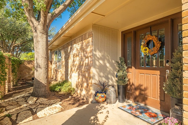 doorway to property with brick siding