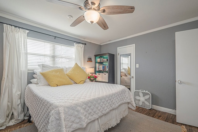 bedroom with ornamental molding, dark wood finished floors, baseboards, and ceiling fan