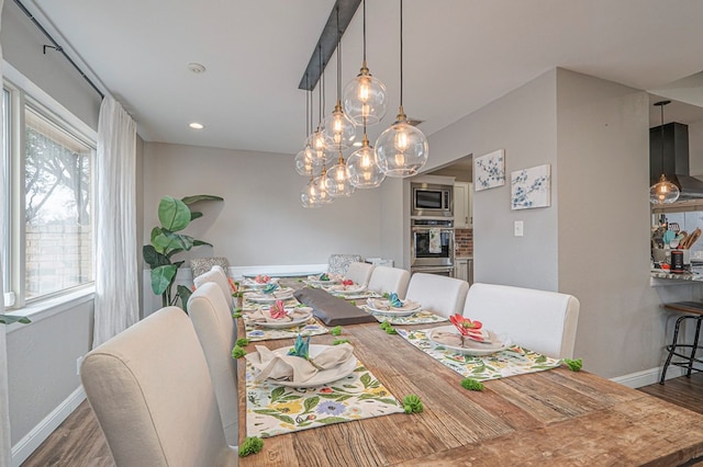 dining room featuring dark wood-type flooring and baseboards