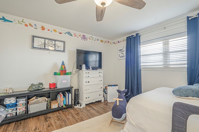 bedroom with a ceiling fan and wood finished floors