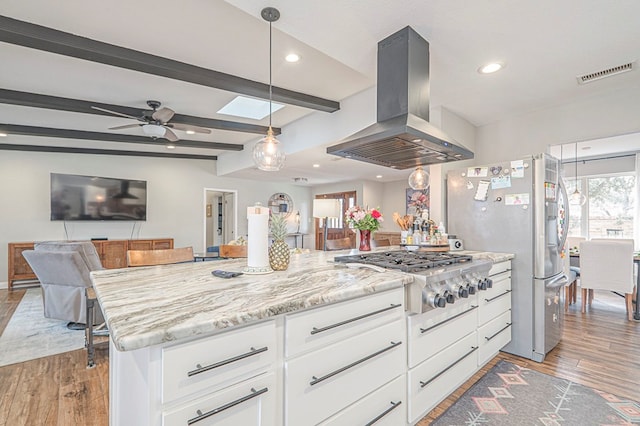 kitchen featuring island exhaust hood, stainless steel appliances, visible vents, open floor plan, and white cabinets