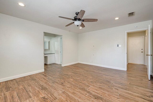 interior space with dark wood finished floors, recessed lighting, lofted ceiling with beams, a tile fireplace, and baseboards