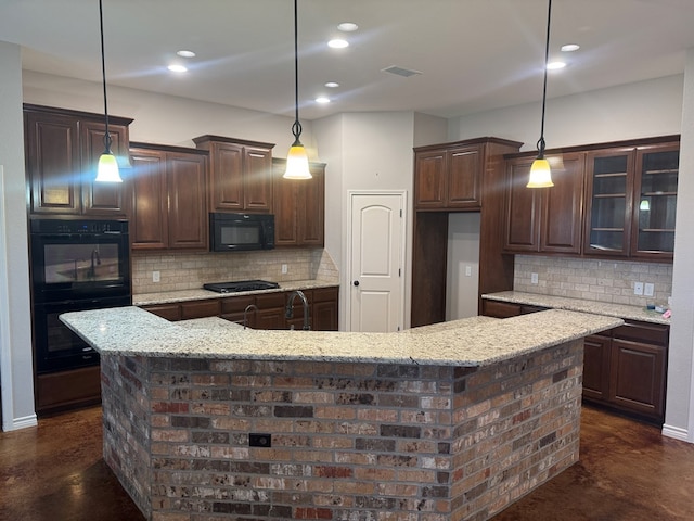 kitchen with dark brown cabinetry, a large island, pendant lighting, and black appliances