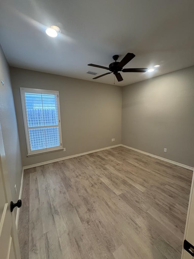 unfurnished room featuring ceiling fan and light hardwood / wood-style flooring