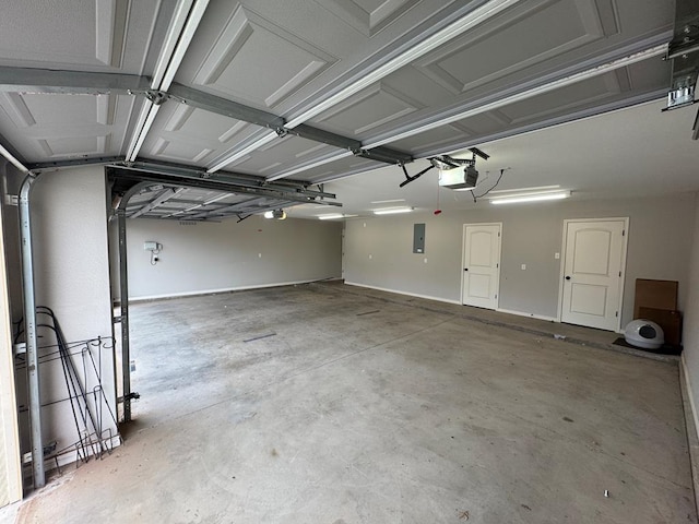 garage with a garage door opener and electric panel