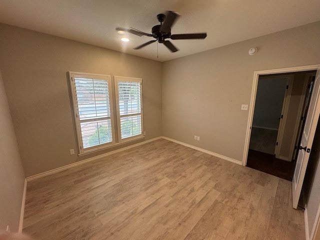 spare room featuring light hardwood / wood-style floors and ceiling fan