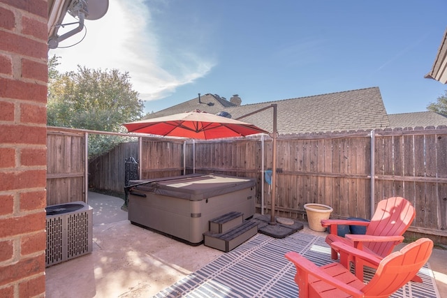 view of patio / terrace with cooling unit and a hot tub