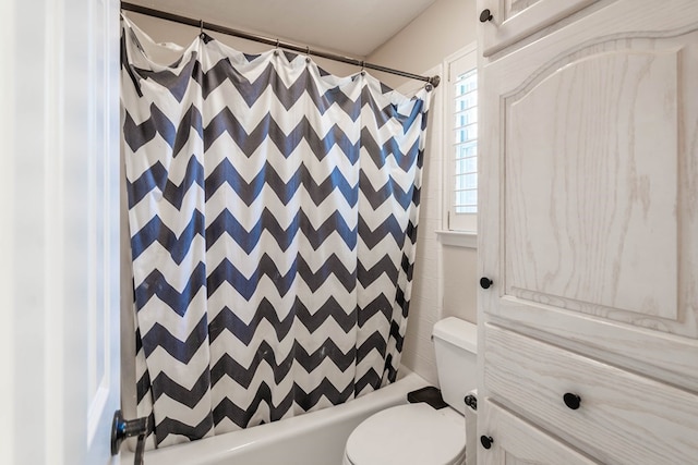 bathroom with toilet and shower / tub combo with curtain