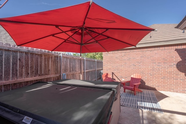 view of patio / terrace with a hot tub