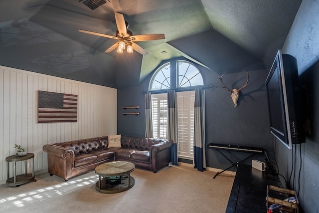 living room with light carpet, wood walls, ceiling fan, and lofted ceiling