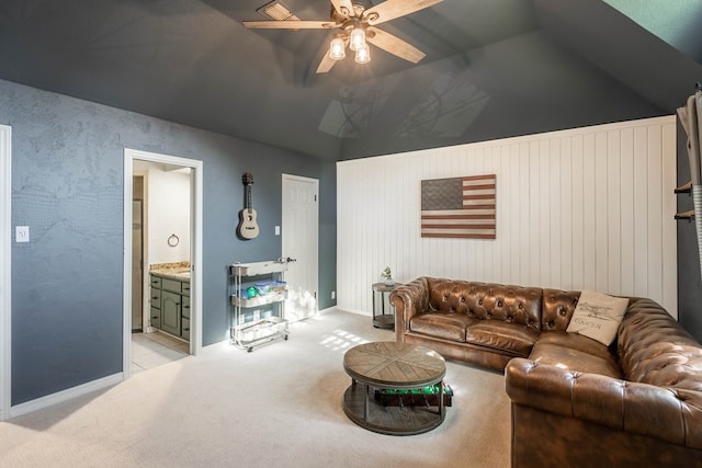 living room featuring vaulted ceiling, ceiling fan, and light carpet