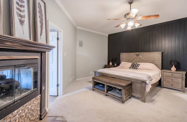 carpeted bedroom featuring ceiling fan, crown molding, and wooden walls