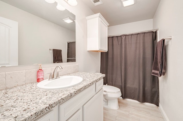 bathroom with toilet, hardwood / wood-style flooring, and vanity