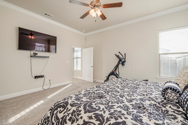 carpeted bedroom with ceiling fan and ornamental molding