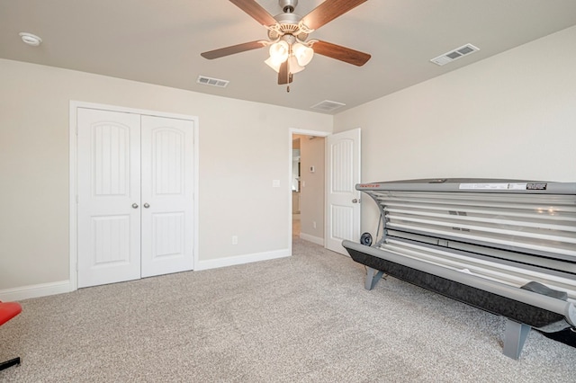 miscellaneous room featuring a ceiling fan, visible vents, carpet, and baseboards