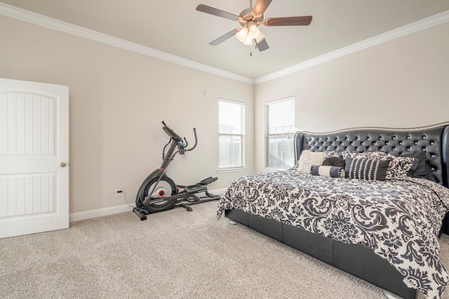 carpeted bedroom with baseboards, a ceiling fan, and crown molding
