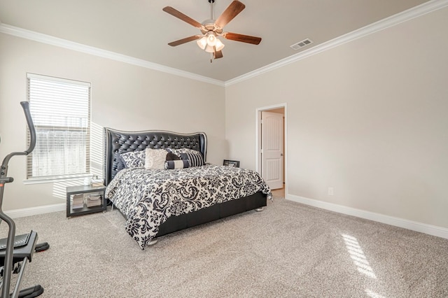 carpeted bedroom with visible vents, ceiling fan, crown molding, and baseboards