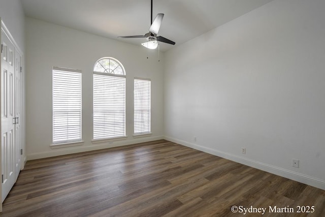 unfurnished room with ceiling fan, wood finished floors, and baseboards