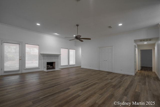 unfurnished living room with crown molding, a ceiling fan, dark wood finished floors, a fireplace, and baseboards