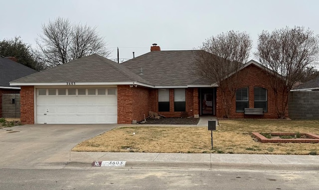 ranch-style home with a garage and a front yard