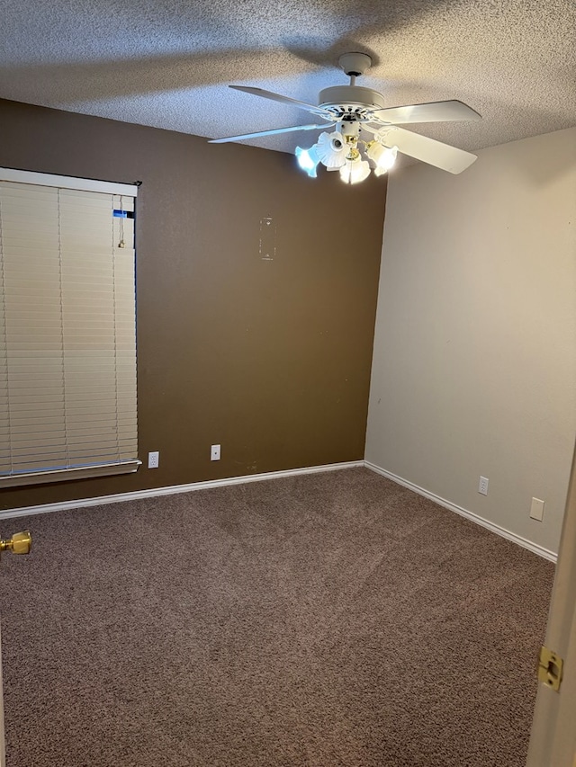 empty room featuring ceiling fan, carpet, and a textured ceiling