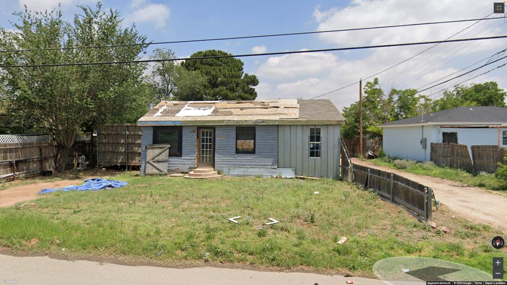 503 Mississippi, Midland, TX 79701 - view of front of house with board and batten siding and a fenced backyard