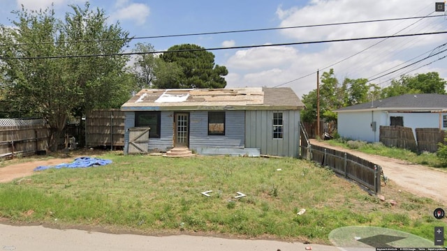 503 Mississippi, Midland, TX 79701 - view of front of house with board and batten siding and a fenced backyard