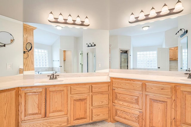 bathroom with sink, a bathtub, lofted ceiling, and tile patterned flooring