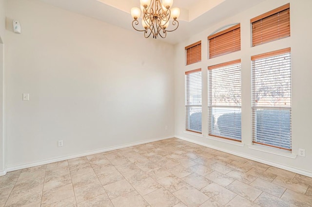 spare room with a chandelier