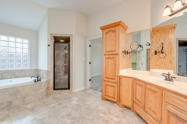 bathroom featuring vaulted ceiling, shower with separate bathtub, and vanity