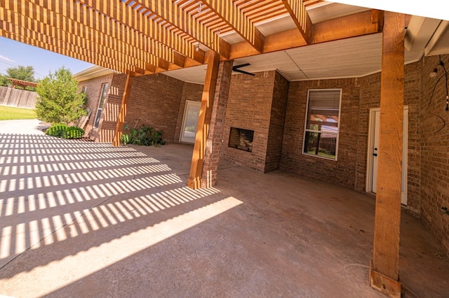 view of patio featuring an outdoor stone fireplace and a pergola