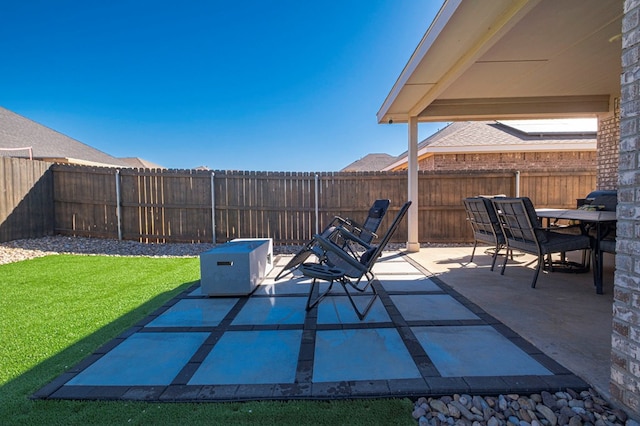 view of patio with outdoor dining space and a fenced backyard