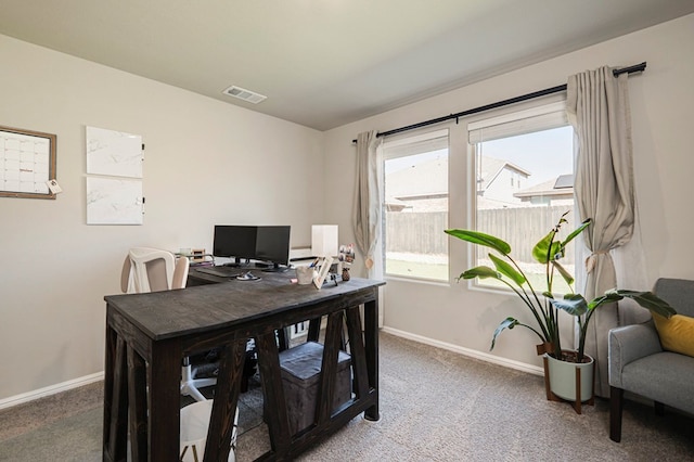 office area with light carpet, visible vents, and baseboards