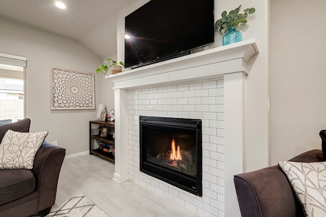 living area with lofted ceiling, a fireplace, baseboards, and recessed lighting