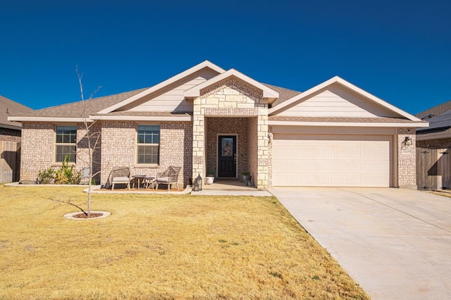 view of front facade with an attached garage, a front lawn, and brick siding