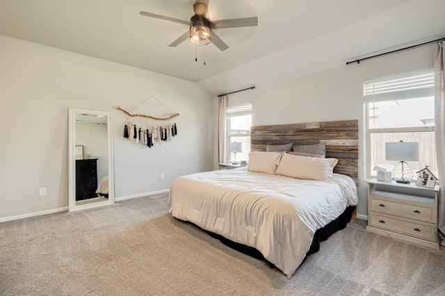 bedroom featuring lofted ceiling, ceiling fan, baseboards, and light colored carpet