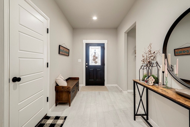 foyer entrance featuring light wood-type flooring, baseboards, and recessed lighting