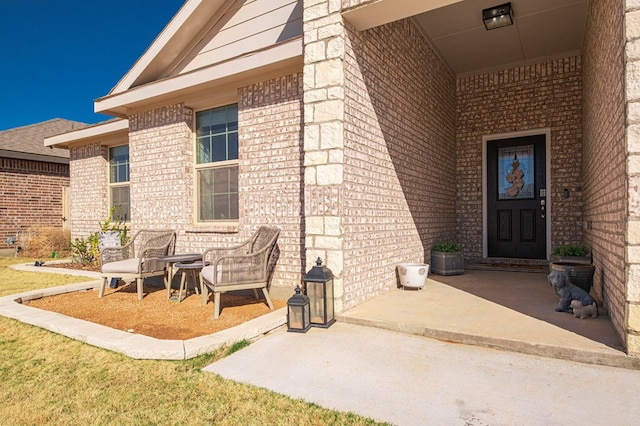 view of exterior entry featuring brick siding