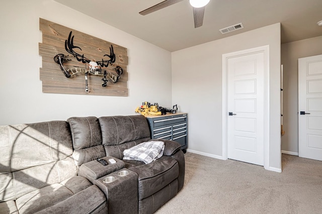 carpeted living room with visible vents, ceiling fan, and baseboards