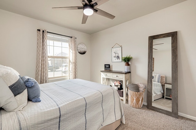 bedroom featuring a ceiling fan, light carpet, and baseboards