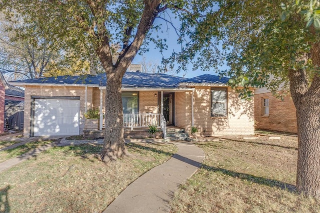 ranch-style house with covered porch, a front yard, and a garage