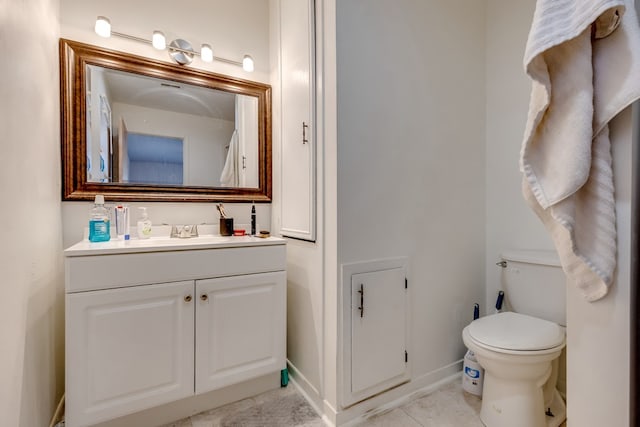 bathroom with tile patterned floors, vanity, and toilet