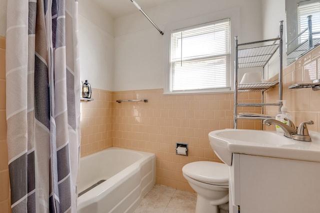 full bathroom featuring tile patterned floors, vanity, a healthy amount of sunlight, and tile walls