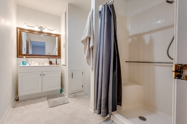 bathroom featuring tile patterned flooring, vanity, and walk in shower