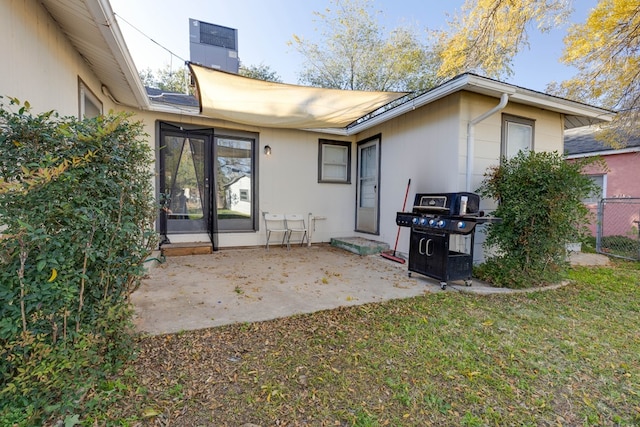 back of property featuring a yard and a patio area