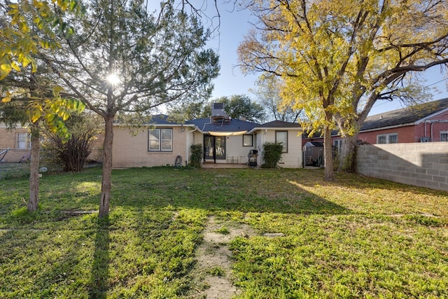 rear view of house with a lawn