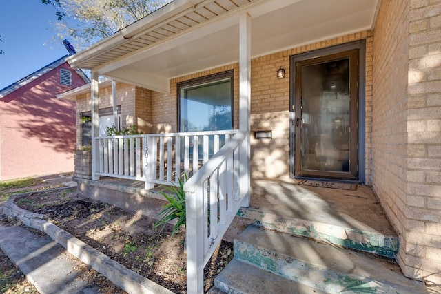 entrance to property featuring a porch