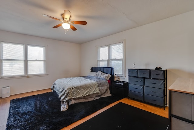 bedroom with light hardwood / wood-style flooring and ceiling fan