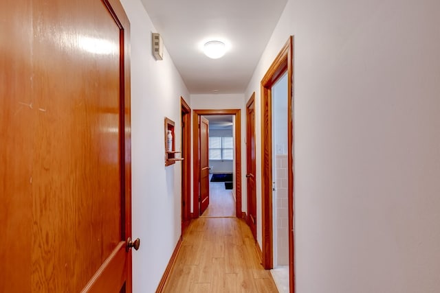 corridor with light hardwood / wood-style flooring