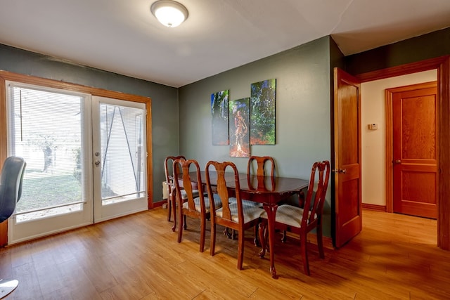 dining area featuring french doors and light wood-type flooring